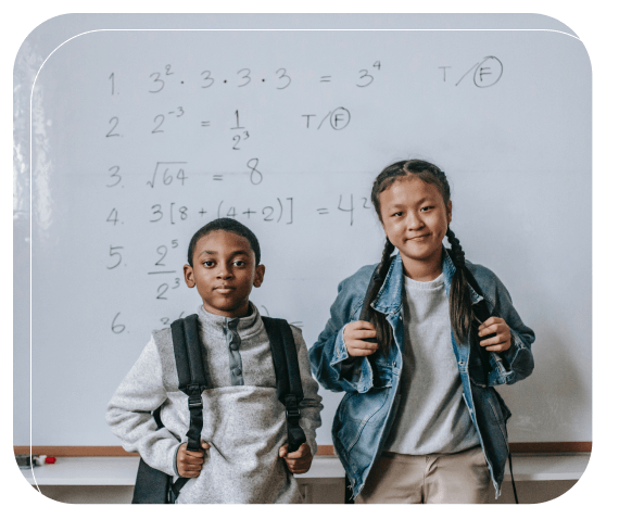 Two students standing in front of an eraser board with mathematics equations